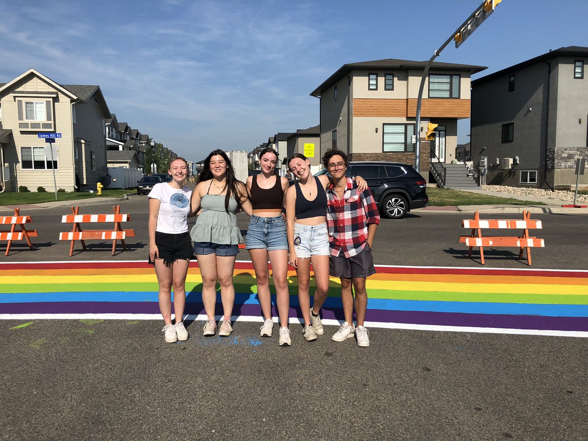 An amazing way to start the day - crosswalk re-painting at <a href="/HarbourLandSch/">Harbour Landing</a>  Thank you <a href="/MrHExperience/">Jason Howse 🌈</a> for organizing and thank you @campbelltartans for showing up to help and fight back against hate! <a href="/RegPublicSchool/">Regina Public Schools</a>