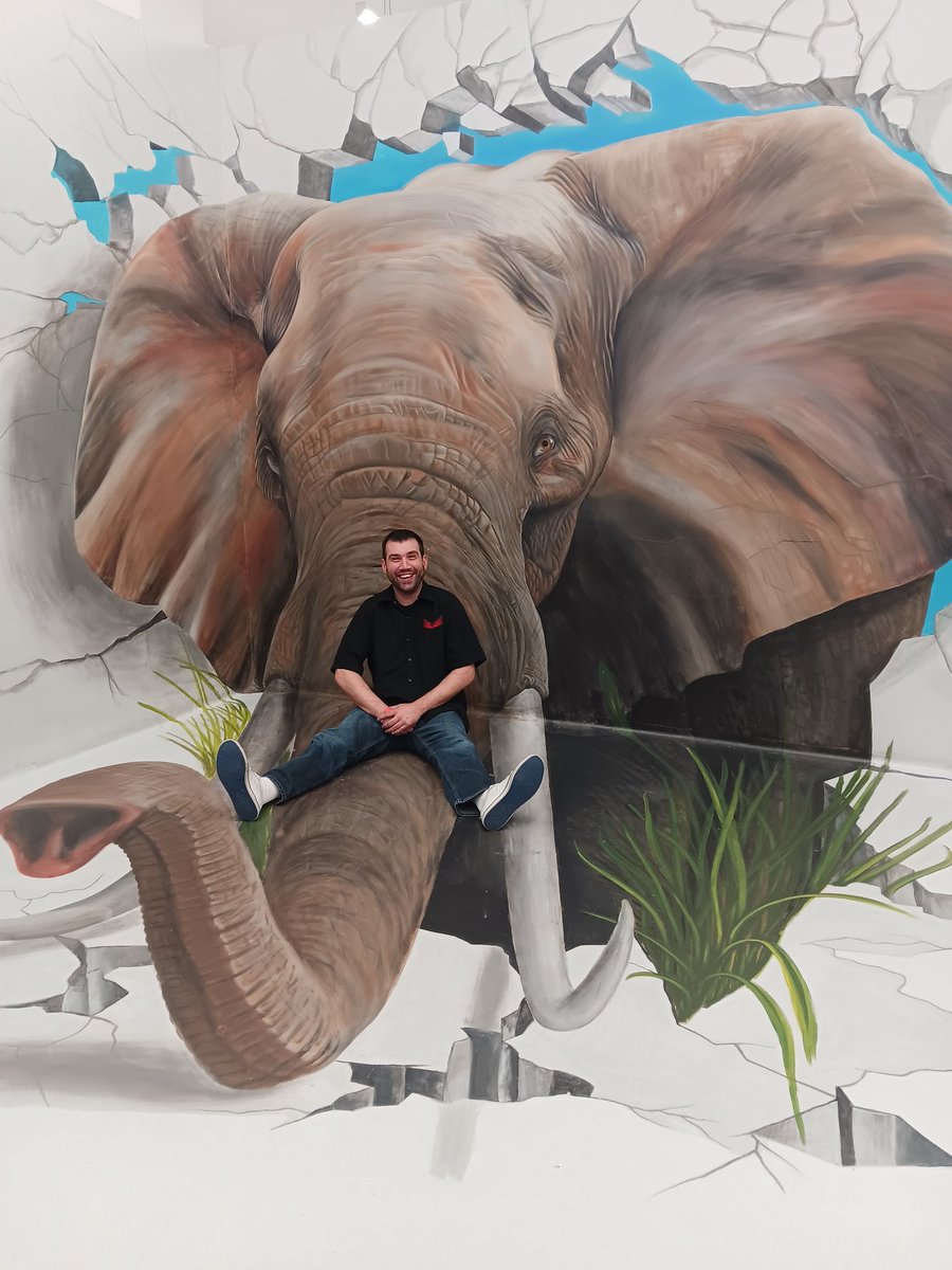 Embracing the Giants: A Man's Tranquil Moment With the Majestic Elephant"
#UrbanJungleArt.