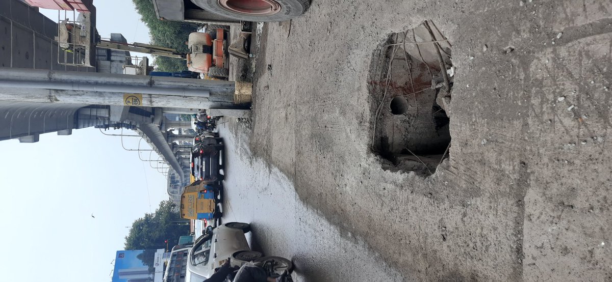 Traffiator's tweet photo. The photos posted are from road, diagonally opposite Novotel Viman Nagar, at 9 am today, my SUV got damaged due to this, and could have landed into huge medical damage as well. How's it that PMC has ignored such a huge issue? Are we waiting for someone to die in that hole? M68104 https://t.co/qx2XD1DT6s