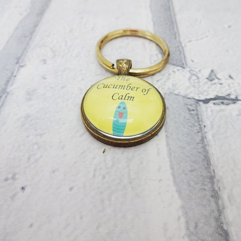 martisanne's tweet photo. The cucumber of calm will keep you cool as a cucumber all day https://t.co/Ze7xyrzaLc #SMILEtt23 #cucumberofcalm #coolasacucumber #cucumberfun #quirkykeychain #youbecool #keepcool #anxietyjewelry #funnykeyring #funjewelry https://t.co/lSWRYM5Sc6