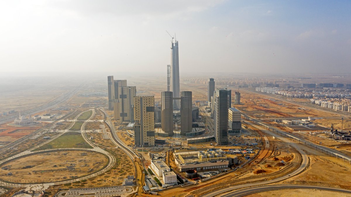 CSCEC_EGYPT's tweet photo. 🏜In the vast desert, led by the iconic tower, the skyscrapers of the New Administrative Capital CBD, rise from the ground. The skyscrapers seamlessly integrated blend with the surrounding boundless desert, creating a magnificent visual effect. 🐫✨🐈 #CSCEC #Egypt #WitnessABetterWorld #CBD #Skyscrapers