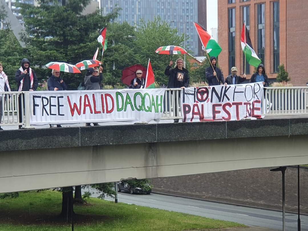 QudsNen's tweet photo. Activists drop a banner today in Manchester in support of Palestinian political prisoner Walid Daqqah, who is facing an imminent threat of death due to bone marrow cancer, and Israeli authorities are refusing to release him. 
 #FreeThemAll https://t.co/9iyryS8JSi