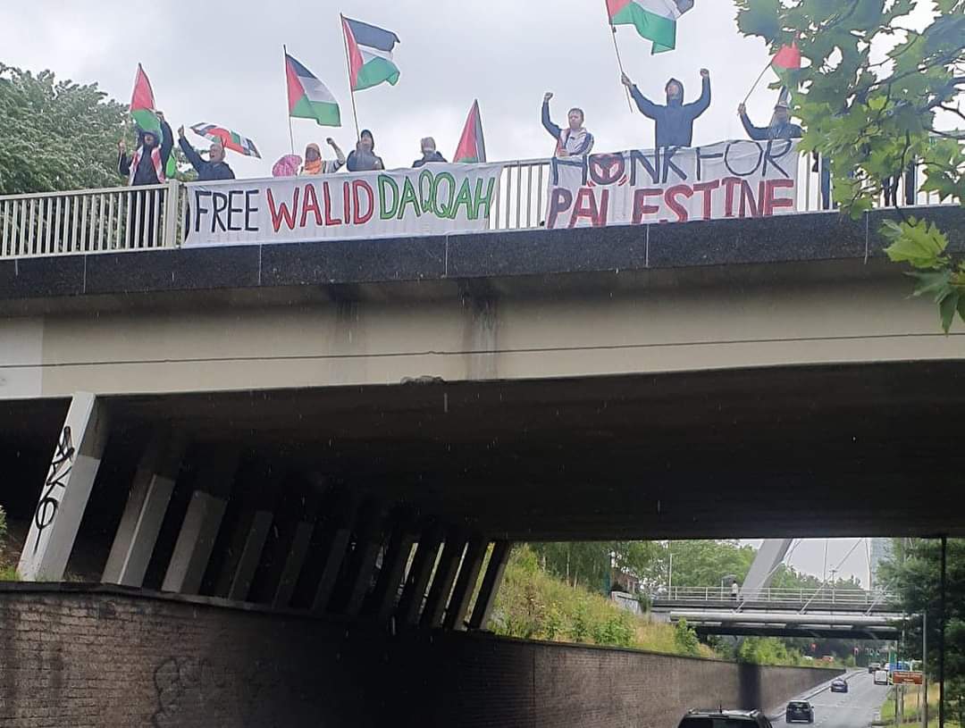 QudsNen's tweet photo. Activists drop a banner today in Manchester in support of Palestinian political prisoner Walid Daqqah, who is facing an imminent threat of death due to bone marrow cancer, and Israeli authorities are refusing to release him. 
 #FreeThemAll https://t.co/9iyryS8JSi