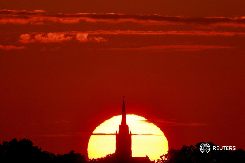 GuyReuters's tweet photo. A church is pictured during sunset as a heat wave hits Europe, in Sancourt, France, July 12, 2023. REUTERS/Pascal Rossignol https://t.co/xmQzp8sfZc