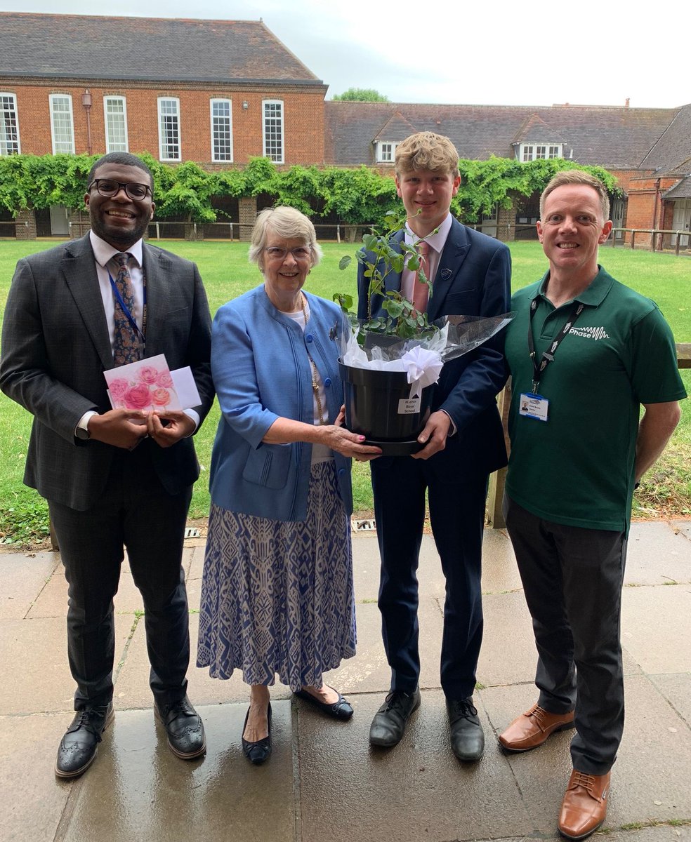 Youth charity <a href="/PhaseHitchin/">Phase Hitchin</a> are celebrating 20 years working with local schools to support young lives. Today our PHASE sponsor, Lady Dixon, visited HBS with Kieran Murphy, PHASE Director, to present Mr Ajagbonna and Head Boy Will Galliford with a 20th anniversary ‘China’ rose.