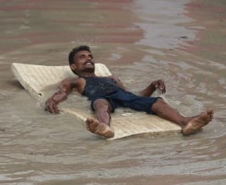tashitobgyal's tweet photo. The flood took over a shelter for the homeless, where he lived. He picked up a ragged old mattress &amp; went for a sail on the ring road. He sang &amp; smiled through the mile-long cruise. He had nothing to lose.
Photo © TashiTobgyal/ @IndianExpress 

#DelhiFloods 
#delhiflood https://t.co/D7j9LAsh5w