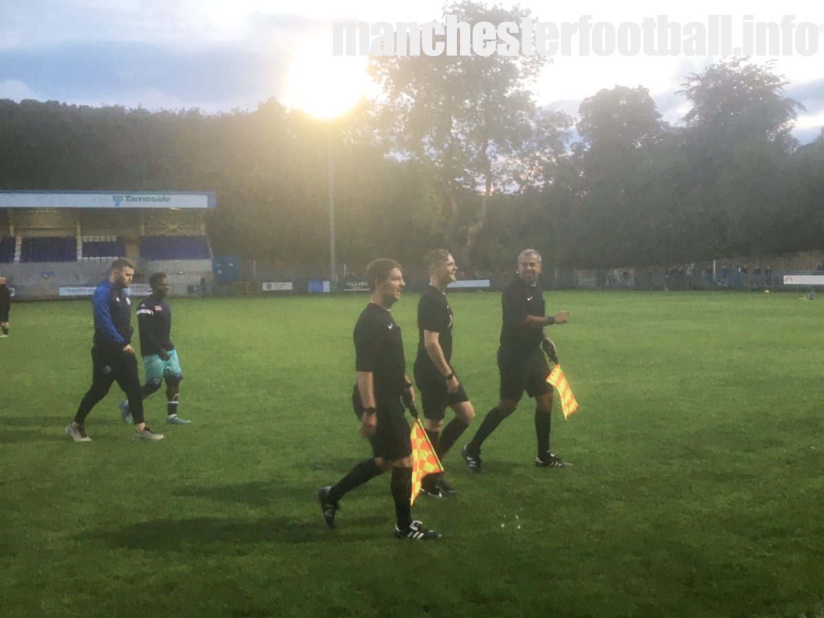 A bizarre moment @StalyCelticFC when assistant referee Jahangir Hussain, pictured right, had to leave the ground to move his car which was causing an obstruction. @AbbeyHeyFC manager Chris Baguley temporarily took over flag duties.