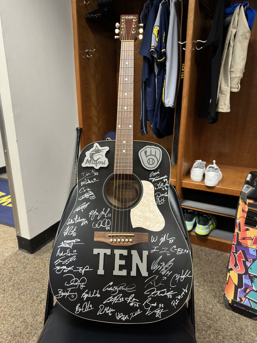 Brewers's tweet photo. Christian Yelich celebrated 10 years in the majors during the All-Star break! 

Today, the team surprised him with an autographed guitar signed by all the players and coaching staff.

Congrats, Yeli! 🎸

#ThisIsMyCrew I @ChristianYelich https://t.co/lJO3I2Tqsv