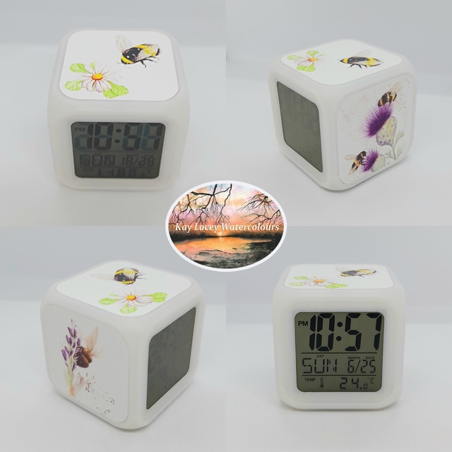 kblacey's tweet photo. This small digital cube clock features 3 of my bee artworks making it both fun and functional.    https://t.co/G75N3QkbGE
#UKGiftHour #UKGiftAM #clock #bees #shopindie #MHHSBD https://t.co/ICPhgHUR7O