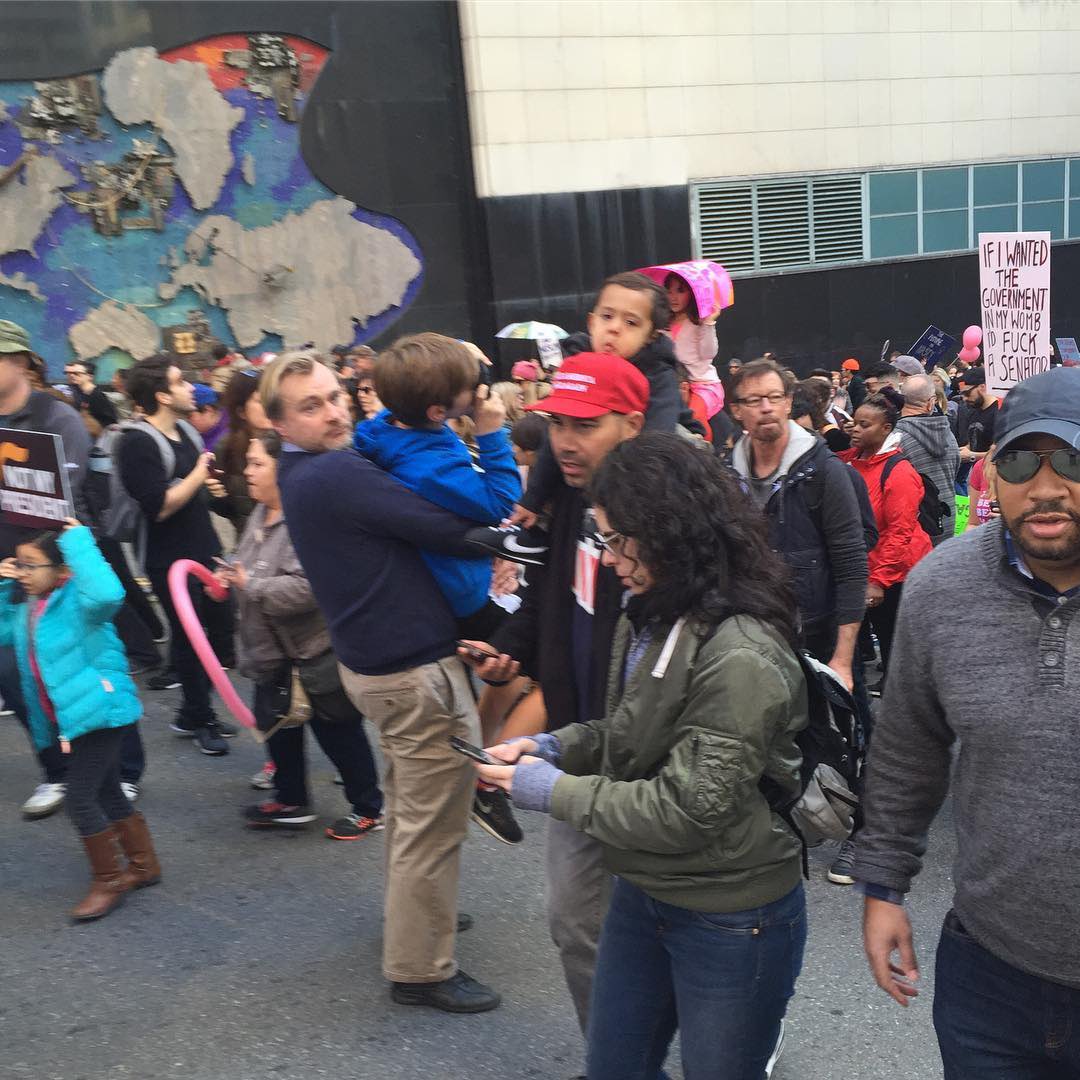 these photos of christopher nolan at the women's march are killing me