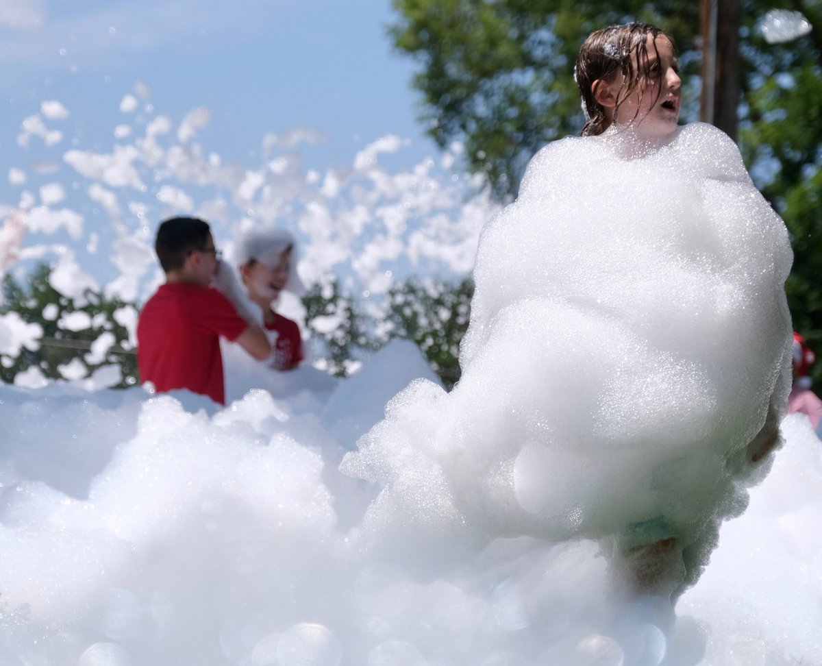 DalaTown's tweet photo. Seven-year-old Cadence MacDonald of Lindsborg braved the drifting snow in Swensson Park to help celebrate Christmas in July on Saturday. The second year of the annual event was a chance for shoppers to meet friends and find great deals in downtown. Photo essay... https://t.co/SdnuyqbPu9