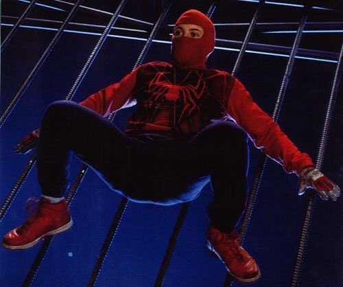 When Spider-Man is not in his costume and he’s wearing regular shoes, why do his feet still stick to walls? 

This isn’t the setup to a joke btw this is a serious question