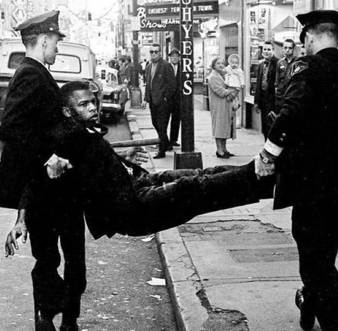 This photograph depicts the arrest of John Lewis in Tennessee in 1961 for his role in organizing and participating in civil rights demonstrations.

In that same year, at just 21 years old, Lewis faced an assault by two men in Rock Hill, South Carolina, as he attempted to enter a