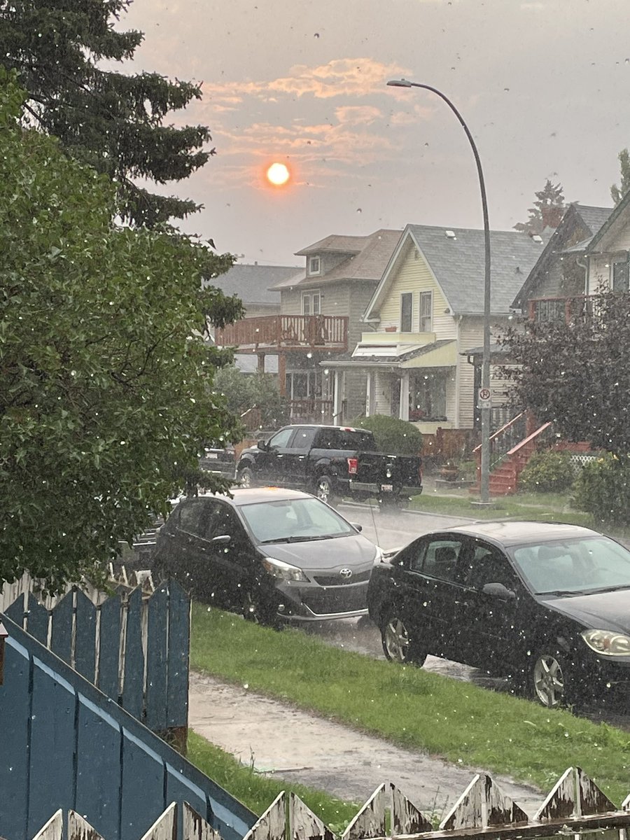 I've seen some weird #yyc weather but watching a red sunset THROUGH a hailstorm feels like a first #abstorm