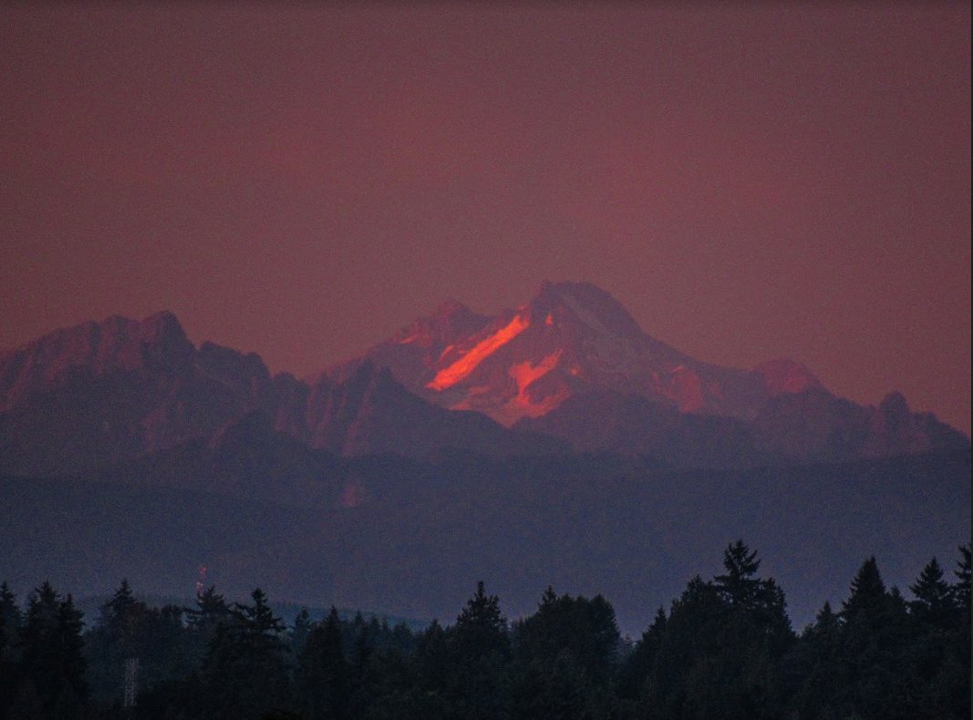 NOAA #Osprey looking at the pretty #sunset tonight in the #Seattle area plus some late day alpenglow on Glacier Peak. Marine air is on the way for the interior arriving early Sunday morning. This will knock about 10 degrees off the highs Sunday versus Saturday. #wawx
