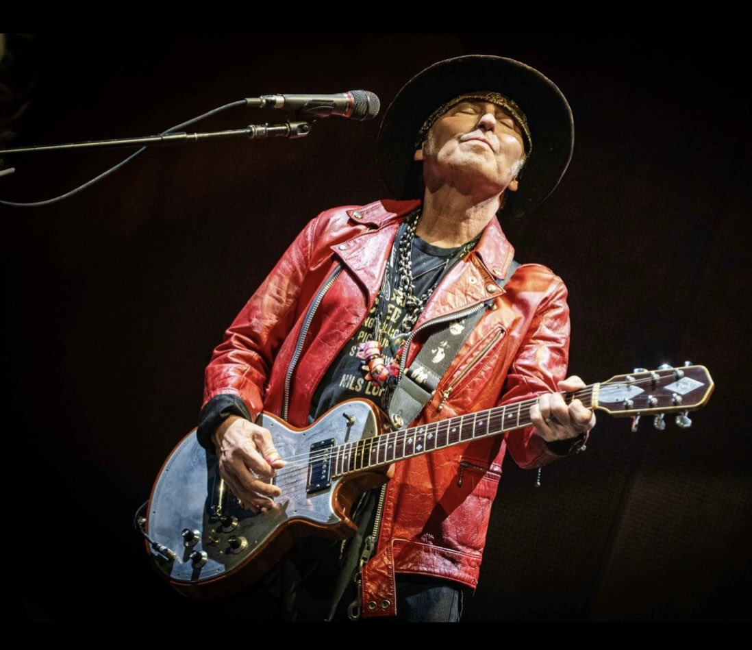 Nils Lofgren wearing the jacket I gave him (which I wore on my first album cover)  and playing James Honeyman Scott’s Zermatis  guitar at the recent Bruce Springsteen show in Hyde Park. Now, that’s what I call flying the flag. Nice one Nils! We love you! XCH