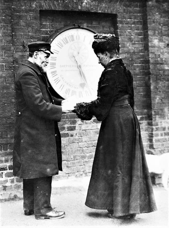 Ruth Belville outside the gates of the Greenwich Observatory, 1908. Elizabeth Ruth Naomi Belville was also known as the Greenwich Time Lady. She was a businesswoman from London. She, her mother Maria Elizabeth, and her father John Henry, sold people the time. This was done by