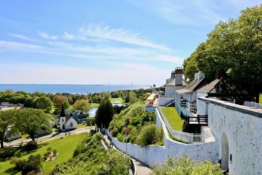 A unique angle of Fort Mackinac overlooking Fort Street, the Fort Mackinac Tea Room, and the Jewel Golf Course.  Of course, like any great Mackinac Island photo, the Mackinac Bridge is also in the background.  #mackinacisland #mackinacbridge #fortmackinac #PureMichigan