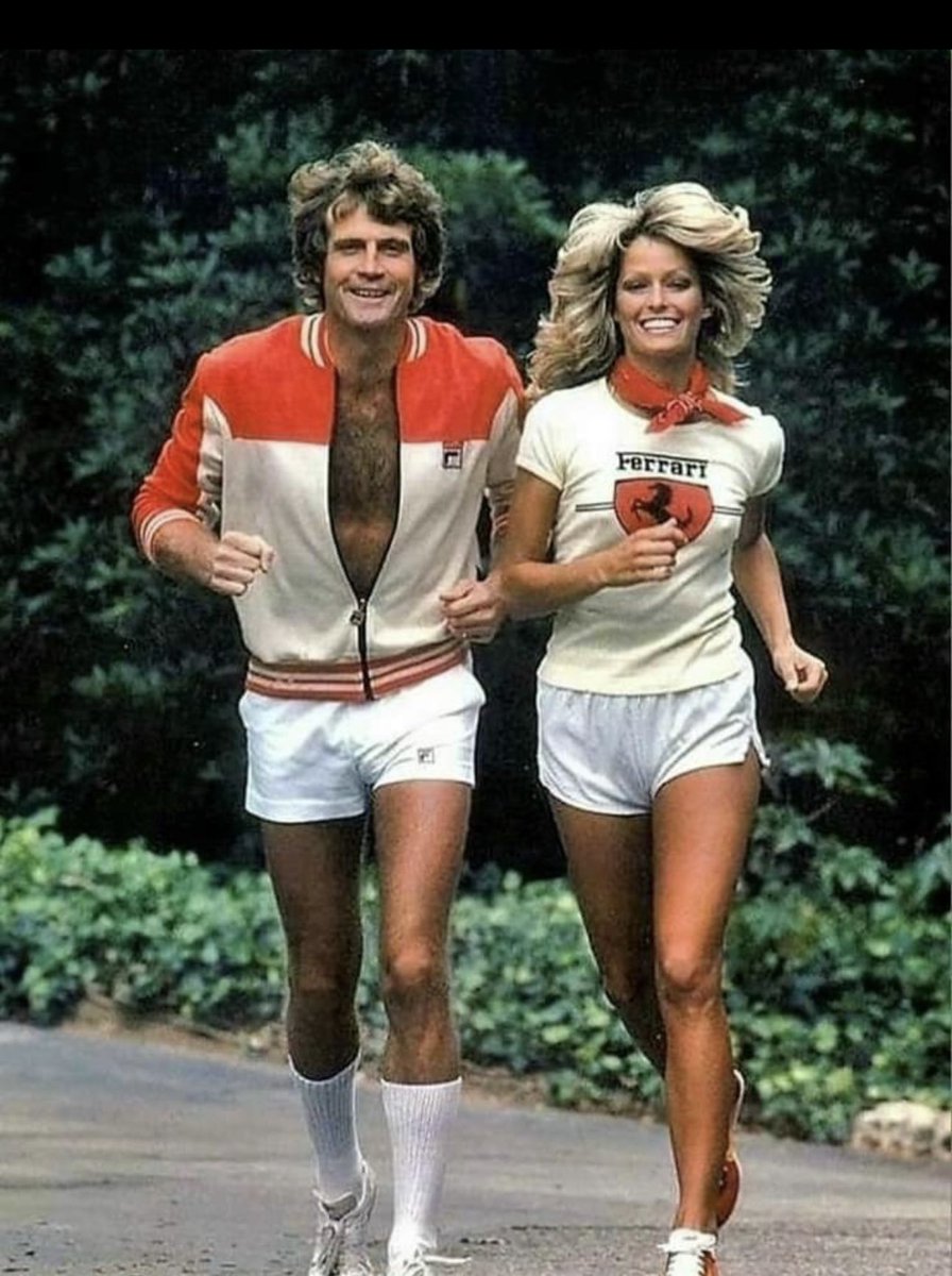Lee Majors and Farrah Fawcett running together in Los Angeles circa 1977.