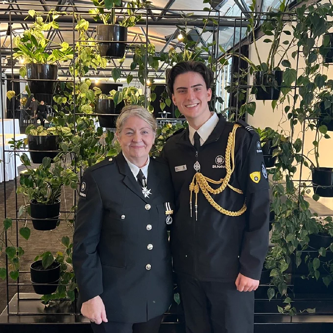 Jane (left) and Nate smiling and posing for a photograph in their Hato Hone St John uniforms