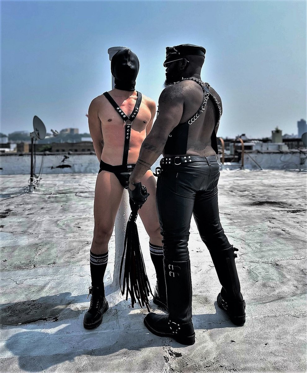 AZ's leather addiction Arrested and handcuffed to a iron post, hooded, wearing a leather harness, boots and jockstrap. Ready for @maliceofny 's target practice.