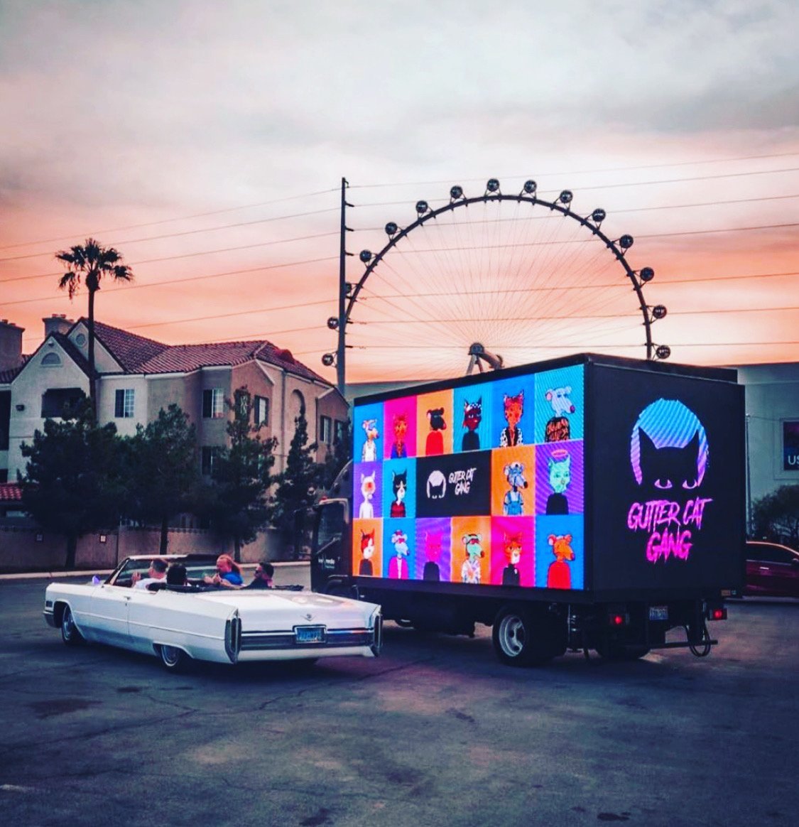 don't care where gutter is now, or what anyone thinks about them. this pic was a cultural event. 

this was the first major meetup in all of web 3. 

this image was an unplanned connection of the slick drop top caddy and the gcg digital truck, and thus, sold me on my journey in