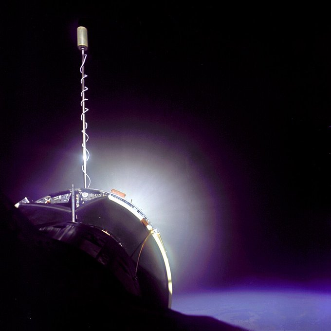 The Gemini 10 spacecraft is successfully docked with the Agena Target Vehicle. The Agena display panel is clearly visible as is glow from Agena's primary propulsion system.