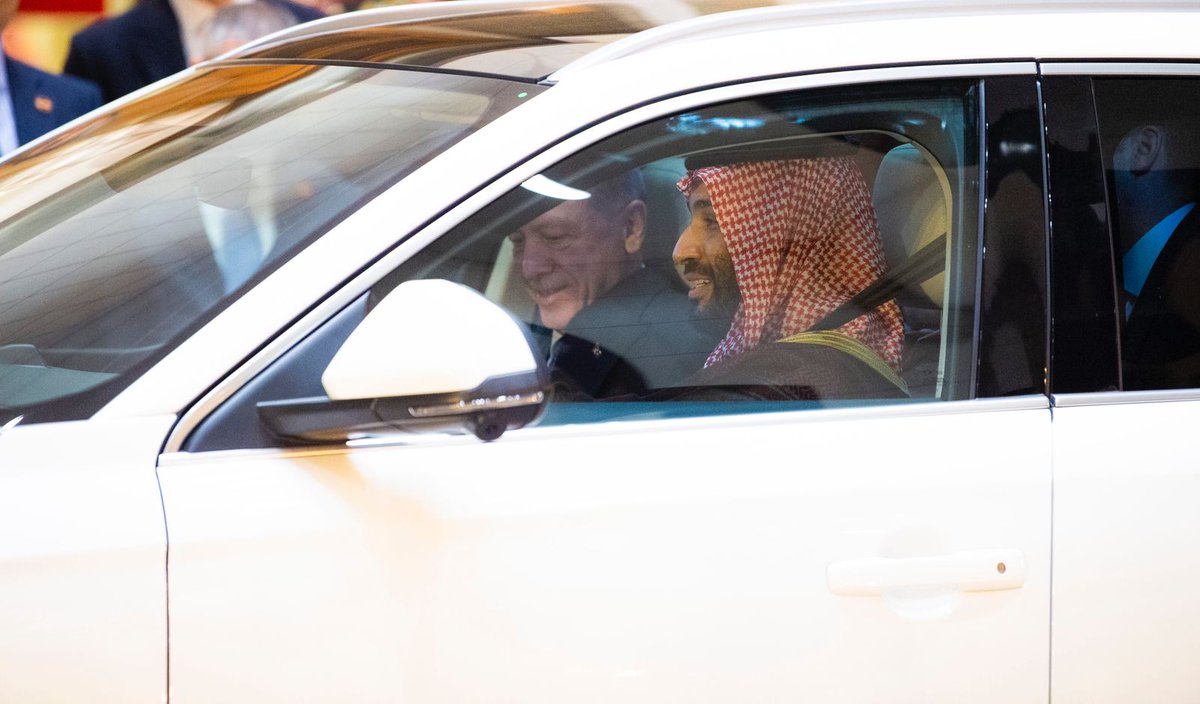 Saudi_Gazette's tweet photo. Crown Prince Mohammed bin Salman accompanies Turkish President Recep Tayyip Erdogan from Al-Sallam palace to his residence in Jeddah in a Turkish-made electric vehicle. Erdogan presented two electric cars as a gift to the Custodian of the Two Holy Mosques King Salman and Prince Mohammed bin Salman.