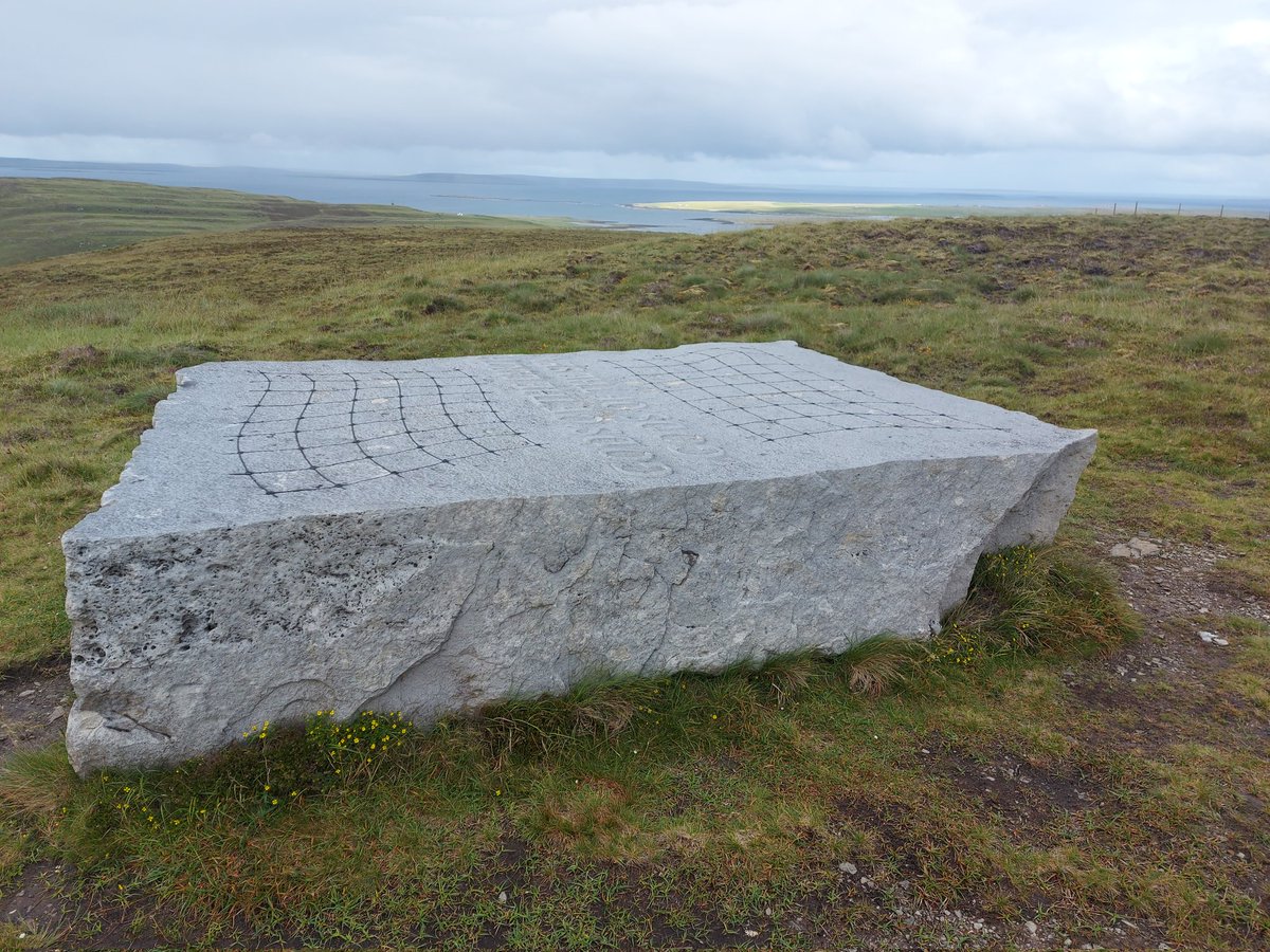 The artwork lies on the flanks of Kirfea Hill at the northeastern corner of the island, with views north to the island of Westray and east to Egilsay (sunlit in this picture).