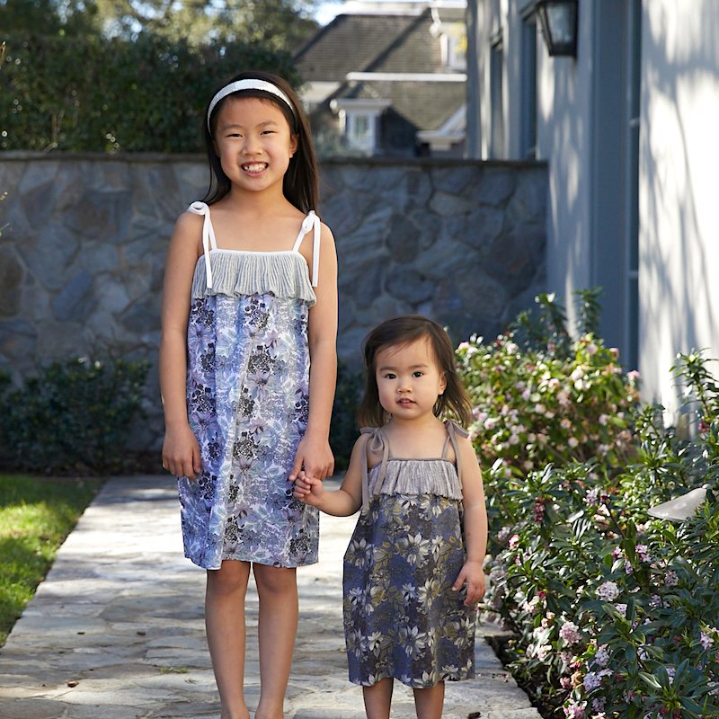 #SISTERS 😍 Looking SO #adorable in matching Malia dresses 💗Gorgeous #cotton floral textile + adjustable tie straps = Perfect #summer #dress ☀️ edenandzoe.com/collections/gi… #fashion #kids #style