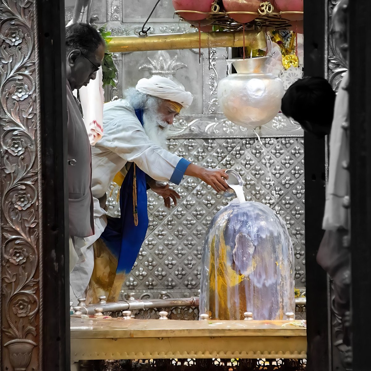 ABhishokarma's tweet photo. Time when Sadhguru visited the Mahakaleshwar temple in Ujjain,

Read out what Sadhguru has to say about the temple.

Sadhguru: This temple was built by a king named Chandrasena. Chandrasena was attacked. He’s a great devotee of Shiva. He was attacked by people who wanted to destroy this culture. 

Ujjain had become a city of devotees and those who sought knowledge. It was almost like the second kashi of India, where knowledge, learning, transmission of spiritual knowledge was the main hub of the town.

That is what ruled the town, and people came to this town for that purpose. It is not on any trading route. So the town grew. It was called Avantika at that time. This town Avantika grew big only as a knowledge hub, as a spiritual hub.

So there were people who don’t like it. There are always people who don’t like it. So they wanted to destroy the city, and they attacked. I won’t go into the entire story.

So he prayed to Shiva. And Shiva appeared in the form of Mahakala and absolved the enemies in a certain way and relieved him of this trouble so that he could continue spreading what he was doing.

Kala. The word kala means 2 things.

Kala means time. Kala also means darkness.

How can one word mean time and darkness? When we say time, in your present experience, time means cycles. Cycles mean physical nature. From atomic to cosmic, from a single atom to the largest cosmos.

Everything is in cyclical motion. If there are no cycles, there is no possibility of physicality. A planet turns around once. We call this a day. The moon goes around the planet. We call it a month. The planet goes around the sun. We call it a year. Like this, it goes. Our understanding of time, our experience of time right now is in cycles. Cycles of sleep and wakefulness. Eating, digestion, hunger. Like this, there are many cycles.

It is only through the circular movement of things do you know time. If there was no circular motion, if there are no cycles in existence, if there is no physicality, you wouldn’t grasp time.

That is time manifesting through physical existence. This physical existence is happening in the lap of a larger non-existence which, in the English language, they may call it space. 

Here we call it kala or darkness. Why we are calling space as darkness is if you want to see light, you need some opaque object, an opaque object that stops light. You can see my hand only because it is stopping light. You cannot see the air because it’s not stopping light. Nor can you see the light in the air because it is not stopping light. 

Anything that does not stop light will not be seen by you. It will be darkness to you.

Either you must see the source of light, or you must see an object that stops light; otherwise, you will have no experience of light. So you see the sun and the moon. The sun is the source of light for us. The moon is reflecting the light. 

In between, is all darkness but light is passing, isn’t it? You don’t see it. But it is definitely passing; otherwise, how would it fall on the moon? So the space is referred to as kala or darkness because space is dark. Only if there is something, it reflects light, and you experience light. 

If there is something, then it is space. So space is referred to as darkness.

Between time and space, why are they mentioned with one word? Because they are one in the sense right now … Let’s say this is point A and this is point B. These 2 points are possible only because there is time. 

It’s not because there is a distance; there is time. Because there is time, there is a possibility of distance or space. If there is no time, there can only be one point, and one point cannot happen in physical existence. 

There can only be polarities. Things can exist only as polarities. So if there is no time, if there was no time, there would be no space. There would be no 2 different things. Nothing could exist. Even nothing could exist. Not just something. 

Even nothing could exist, so the basis, the fundamental basis of existence is known as kala or the time. Only because there is time, there is room for space. Otherwise, there would be no space.

As right now, your experience of time is only in cyclical movements. Your experience of time is only an expression of physical nature because physicality exists only because of cyclical movements. 

The entire aspiration, the spiritual aspiration is to attain liberation, means you want to transcend the ways of physical. Or, in other words, you want to transcend the cyclical nature of existence. 

Transcending the cyclical nature of existence means transcending the repetitive process of life. Transcending repetitive processes of life means transcending the compulsiveness of who you are.

From compulsion to consciousness, from compulsiveness to consciousness. This is the journey. So if you want to move from compulsiveness to consciousness, the limited experience of time that you have right now, which is an expression of the cyclical movement of physical existence, if you experience time without the basis of physicality, or without the limitations of physicality, then we call that time as Mahakala.

Mahakala is the lamp upon which creation is a smattering of things. Huge galaxies, but still, they’re just small specks of creation. The rest is all empty space. 99% or 99 and more percent of an atom is emptiness. That is Mahakala. Though the atom is in cyclical movements, over 99% is emptiness. In the larger cosmos, over 99% is emptiness. Huge galaxies in cyclical movements, but over 99% is emptiness. So it is in the lap of Mahakala that creation happens. If you are involved with limited specks of creation, then you experience time as a cyclical movement.

This dimension is referred to as samsara, which means cyclical movements. If you transcend this, then we call this virargu. This means you have become transparent. If you are transparent, you don’t stop light. If you don’t stop light, this means you have become free from the compulsive nature of life, of the cyclical movement life. If you become free from the cyclical movement of life, then we say you are in mukti, or absolute liberation. Those who are aspiring for mukti, those who are seeking absolute liberation, for them, this dimension that we are referring to as Mahakala becomes of paramount importance.

The Mahakala Temple, the linga that is consecrated there, is a phenomenal nature. It will shake you from the root of your existence. It is really an incredible consecration. It is just done for this purpose, but in some way, it dissolves you. There is a dimension of Mahakala in the Dhyanalinga, but it is cloaked so that only those who seek, for them, it will be available. There it is a little more very certain fragrance to the way he finds expression. There is a certain forcefulness, raw forcefulness.

One must be ready to go into this temple properly because it’s of tremendous power, and it is not for the faint-hearted. It shakes you from inside. Because that is the nature of Mahakala that in the very presence of what this Mahakala rupa is, is when you go there, everything is gone. Everything is burned into ashes. That means you become free from the physical. That means it pushes you, it propels you towards your ultimate liberation.

You want to do the gently. We have everything here. You want to do it in a "boom" way. You really want to be pushed hard, and you are not faint-hearted, then the Mahakala Temple is a phenomenal process, and this April/May is very significant. We are planning to transport a few thousand people from Damalatu so that something is shaken. #Sadhguru #sadhguruwisdom