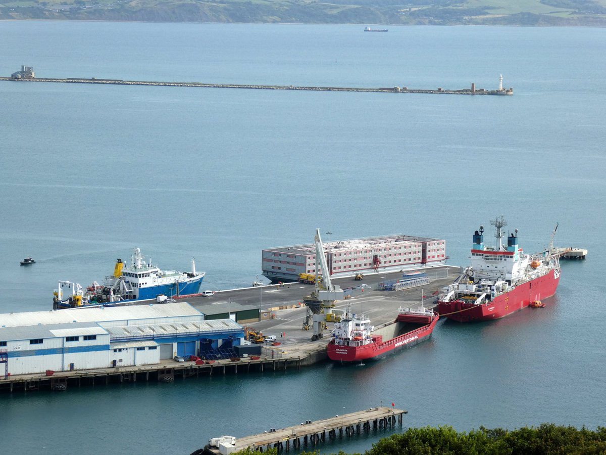 SeanThe1andOnly's tweet photo. The Bibby Stockholm has docked at Portland port. It's finally here. Checked in for 18 months at the docks let's see what happens. 

#bibbystockholm #barge #port #asylumseekers #workhasbegun #docks #uk #news #watchthisspace #portland #dorset https://t.co/zBgQD05kP7