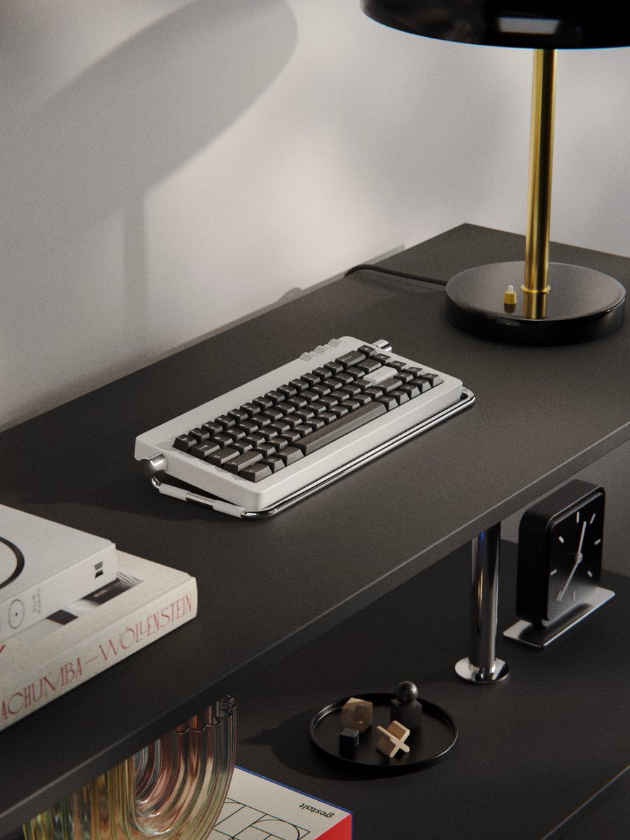 timothyachumba's tweet photo. A bauhaus inspired keyboard next to a bauhaus lamp  above a bauhaus table clock along side some bauhaus  chess pieces on a bauhaus shelf. https://t.co/Q1l15gH2jG