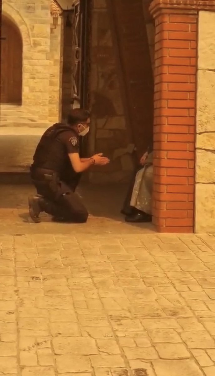 Spyros_Litsas's tweet photo. A Greek Policeman being in danger himself because the wildfire is getting closer, tries to convince one of the nuns in the Monastery that is close to the head of the fire to evacuate with him. #Respecr @hellenicpolice 🇬🇷 https://t.co/RZYvHzG5Ay