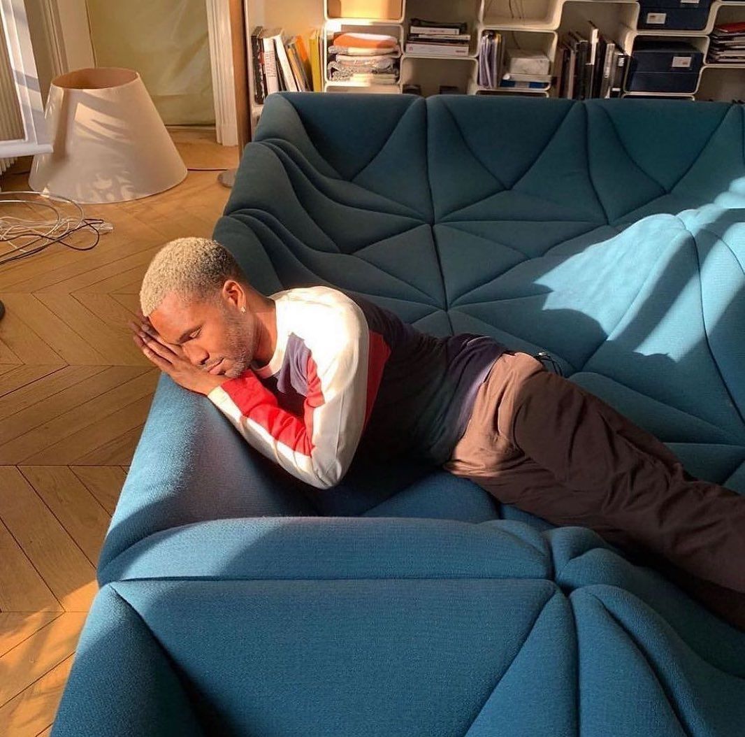 designdocument's tweet photo. Frank Ocean laying on "Dune" Sofa by Pierre Paulin (1970)