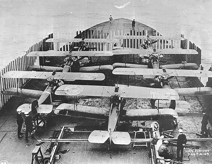 StowAero's tweet photo. #OTD 1918: 
7 Sopwith Camels took off from the converted large cruiser HMS Furious in a  raid on the Imperial German Navy's  at Tondern and destroyed two Zeppelins. It was the first-ever attack made by wheeled aircraft flying from a carrier flight deck.
Images: IWM https://t.co/EkX0kjTyn3