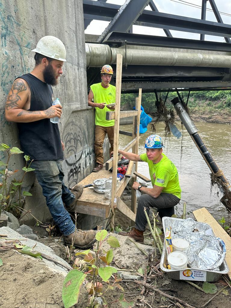 WCKitchen's tweet photo. Our team is providing fresh meals and water to crews repairing essential infrastructure in Vermont damaged by debris and flood water. This team working on damaged sewer pipes in Johnson was very grateful to take a lunch break with WCK-provided food.
#ChefsForVermont https://t.co/1cKrAyqIOm