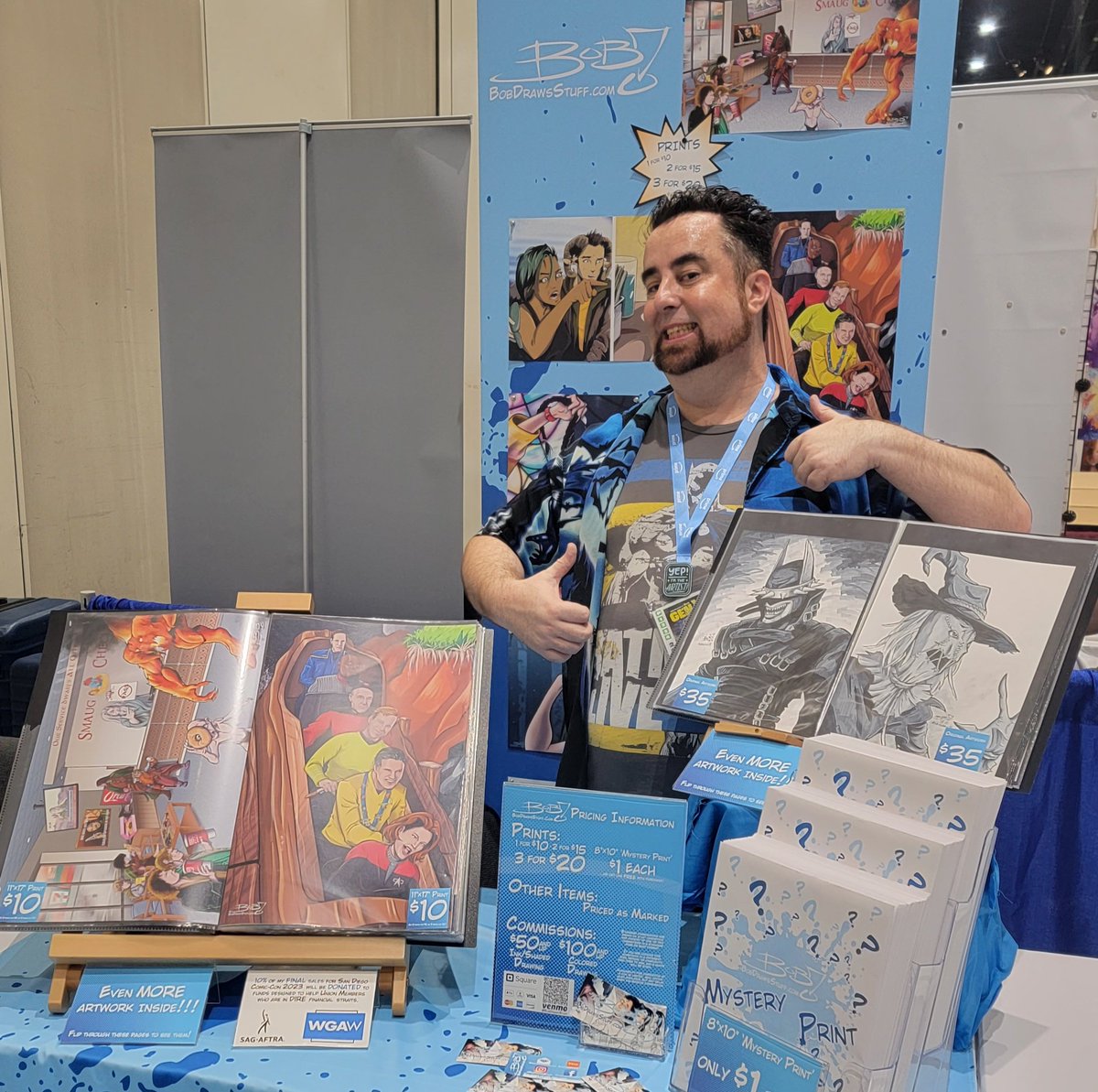 BobDrawsStuff's tweet photo. Compare this picture to Sunday's.. 4.5 days from now...  Anyway, Comic-Con International is a GO!

If you want to find me... or my art... come to DD-14 in Artists' Alley!

#comiccon #comiccon2023 #sdcc #sdcc2023 #artistsalley #artistalley #bobdrawsstuff #dd14 https://t.co/6kFWKcjxNu