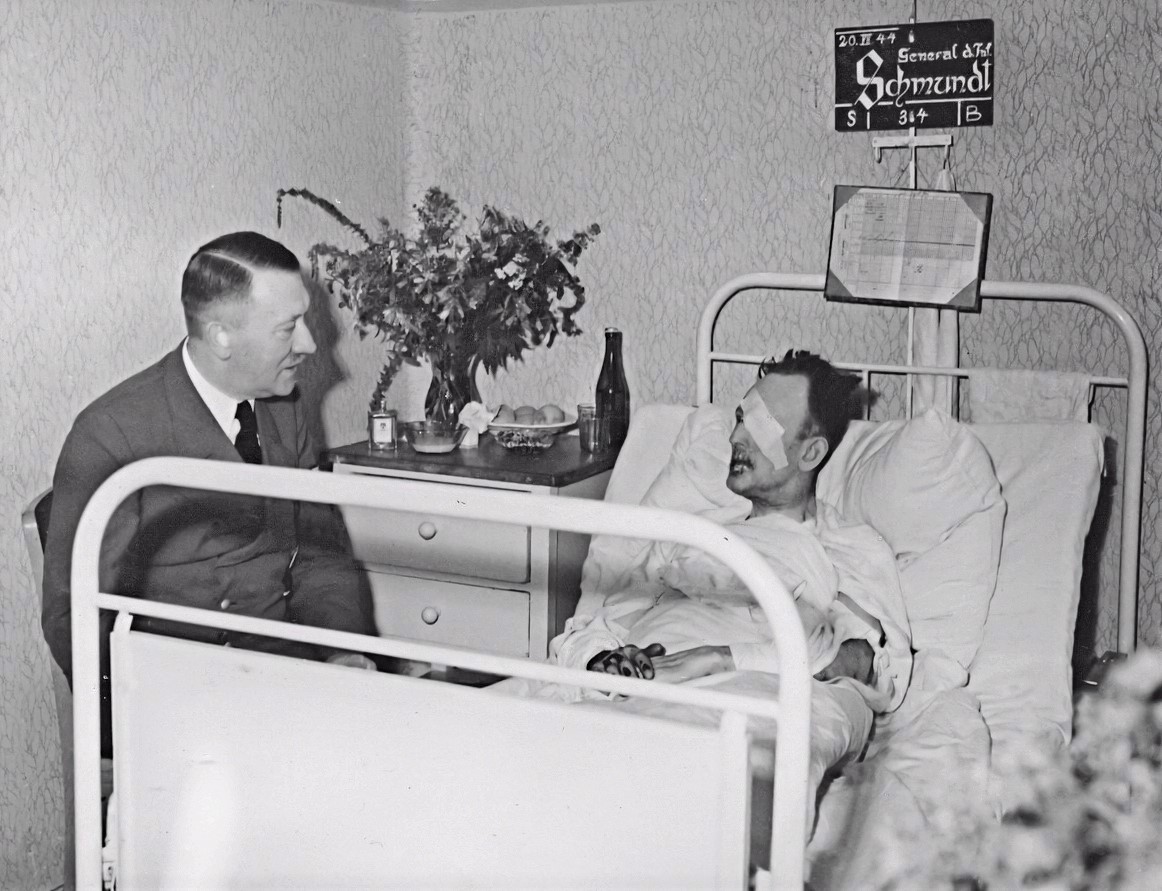 Steeled247's tweet photo. The Death of Hitler's 'Best Man' 
General of the Infantry Schmundt 
August 13, 1896 - † October 1, 1944.
Lieutenant General Schmundt considered Colonel Count Stauffenberg to be very capable and therefore had him flown out of Africa wounded. At the instigation of Tresckow (leading head of the military resistance), he was transferred to the staff of the reserve army with Schmundt's help. This was the only way he could later take part in the briefing at the Führer's headquarters on July 20, 1944. At the situation meeting on July 20, 1944, Schmundt (7) was directly in front of the bomb. Schmundt lost his left eye and suffered burns and severe injuries from splinters to both legs. On July 25, Hitler visited his confidant in the Carlshof military hospital near Rastenburg and promoted him to General of the Infantry. By the end of September 1944, however, Schmundt's health deteriorated rapidly. On October 1, 1944, he died in Carlshof.  After his death Hitler called him his 'best man'. 
According to military historians, Schmundt was a convinced National Socialist, worst Anti-Semite and unconditionally devoted to Hitler. (Karma?)