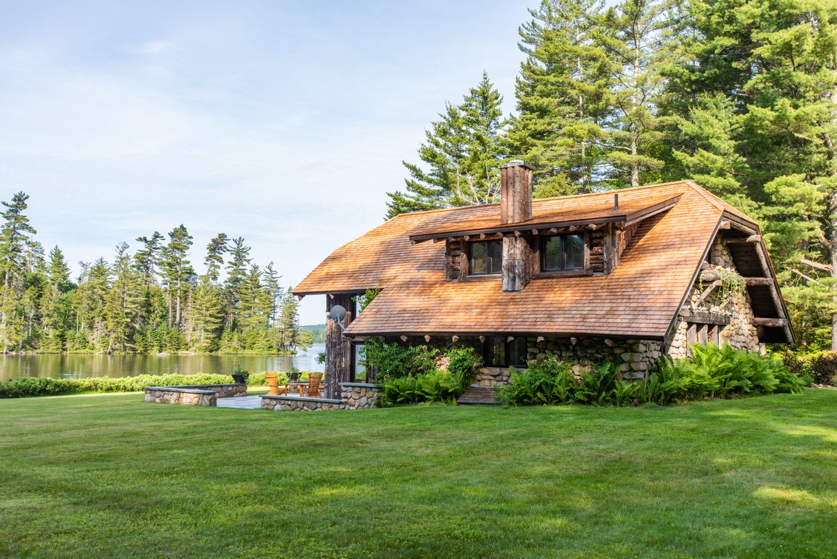 The Gardener’s Cottage - a favorite place to sit &amp; relax with family/friends. This charming &amp; bright 1-bedroom stone building overlooking the #lake, with a beautiful patio, is a secluded accommodation for 2 in the group. #luxurytravel #adirondacks #jetset #adks #travel #private