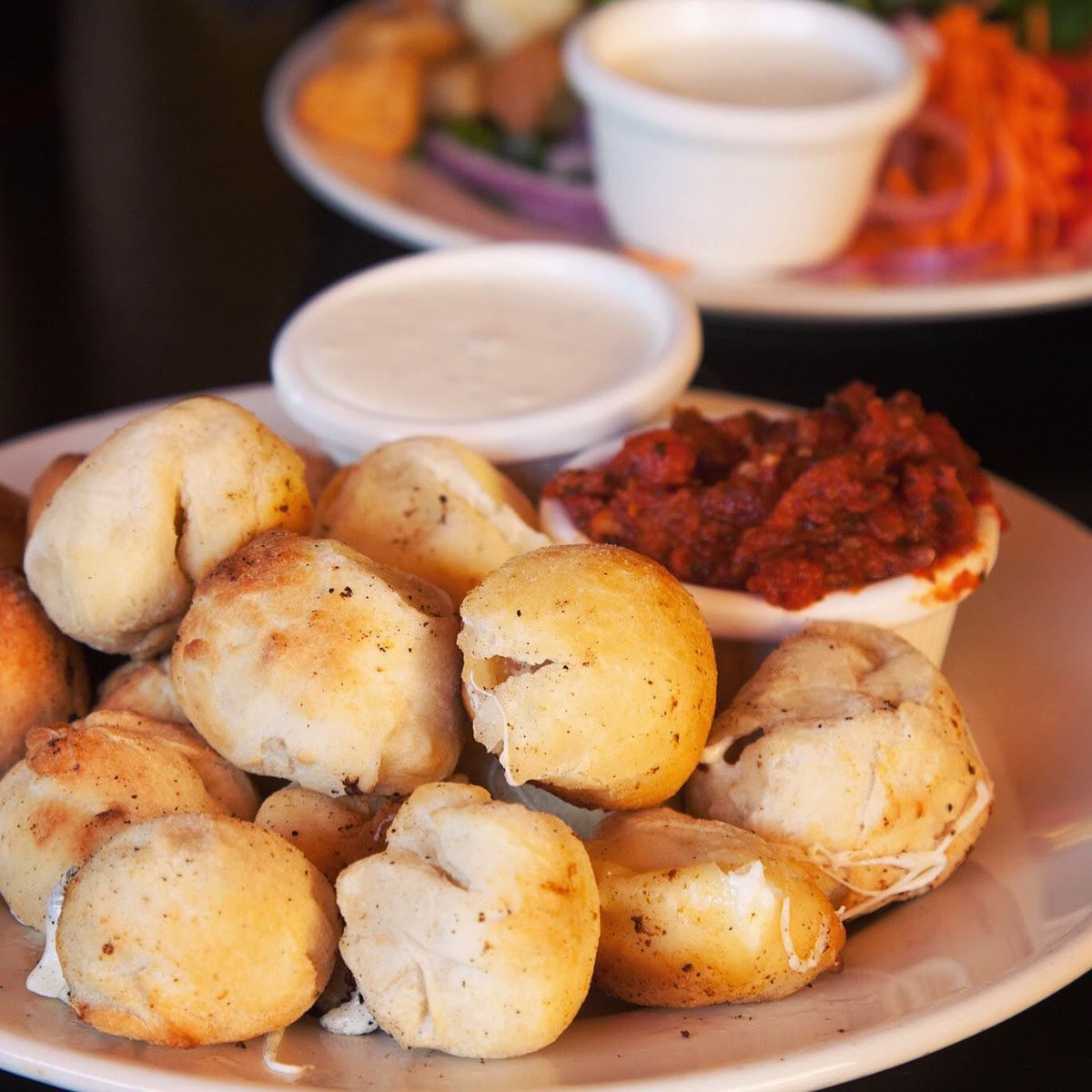 Cheese Balls! Handmade fresh daily. Get them filled with mozzarella cheese, or mozzarella cheese and jalapeños or bacon. Served with marinara sauce on the side. #cheeseballs #tacoma #tacomapizza #jalapenoballs #baconballs #spanaway #tacomaeats #tacomalocal #pugetsoundpizza