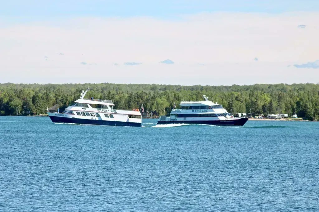 I was able to capture this photo of the Star Line Hydrojet Ferry and the Star Line Catamaran Ferry departing/arriving at St. Ignace.  It's one of my favorite Mackinac photos! #mymackinac #starlinemackinacislandferry #mackinacisland #stignace #puremichigan