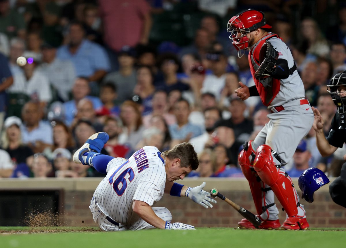 Chicago Cubs third baseman Patrick Wisdom (16) is hit in the head with a pitch in the seventh inning of a game against the St. Louis Cardinals at Wrigley Field in Chicago on Thursday.  Wisdom was evaluated by medical staff and stayed in the game.