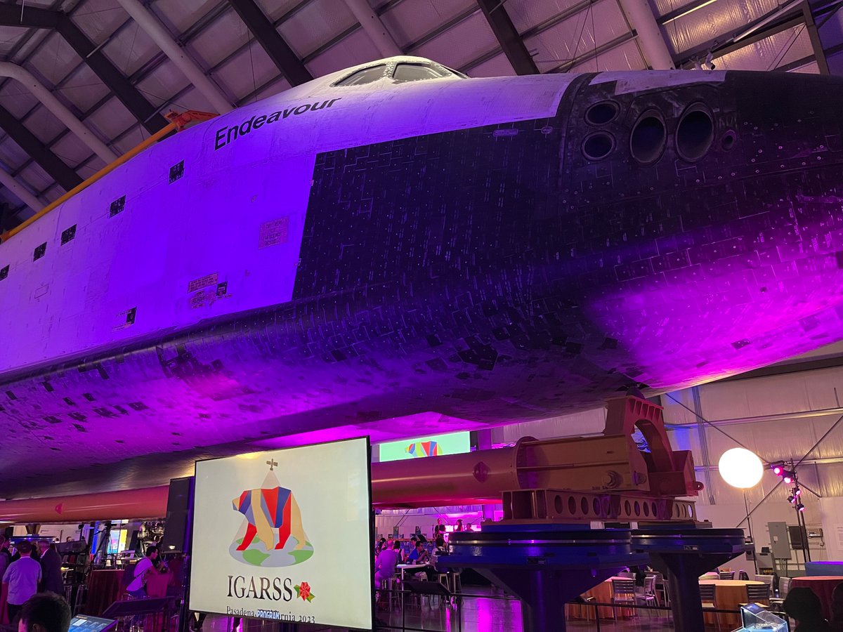 Standing under the #SpaceShuttle #Endeavour @casciencecenter is a lovely way to spend an evening Thanks @IEEE_GRSS @igarss #IGARSS2023 for the space and magic! (with another logo by @CynthiaGWalker)