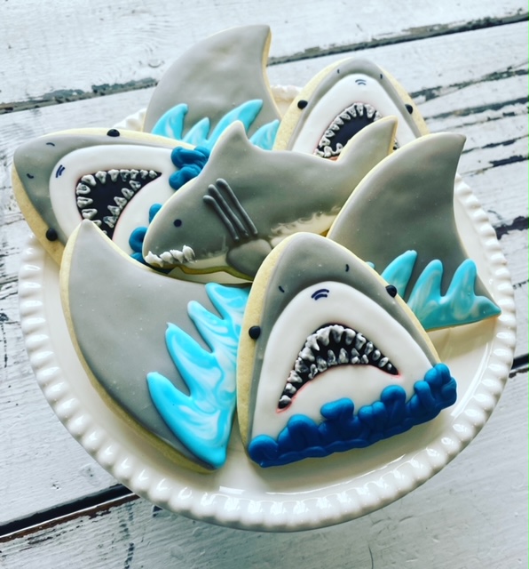 🦈 We've got jaw-some Hand-Decorated Butter Cookies available at the Café just in time for Shark Week! Stop by and grab some to snack on while you tune in.