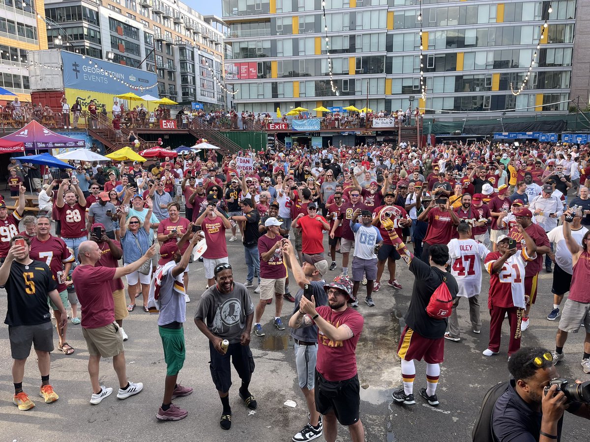 stevesolomon's tweet photo. A historic day in DC sports, and @scottlinn_ was there, somewhere in this picture at the Burgundy and Sold rally celebrating the sale of the Commanders by Dan Snyder to Josh Harris.  Subscribe and listen at https://t.co/ON6lteyw2K https://t.co/sWOIzmZ8NM