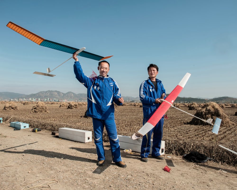 Sariwon, 2017. Two aeromodelers use their free time to indulge their passion in the rice fields, south of Pyongyang. By @stephan_gladieu 🇰🇵