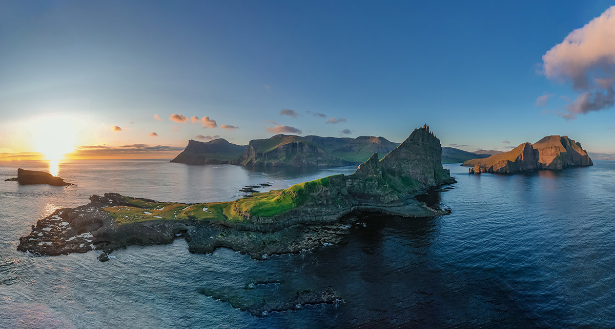 The sun's golden kiss adorns the Faroe Islands, as the horizon ignites in a breathtaking symphony of colors with the Tindhólmur island as the foreground - also nicknamed the sleeping dragon island #landscapephotography by Andrei Vladut Antal for bluegate.fo