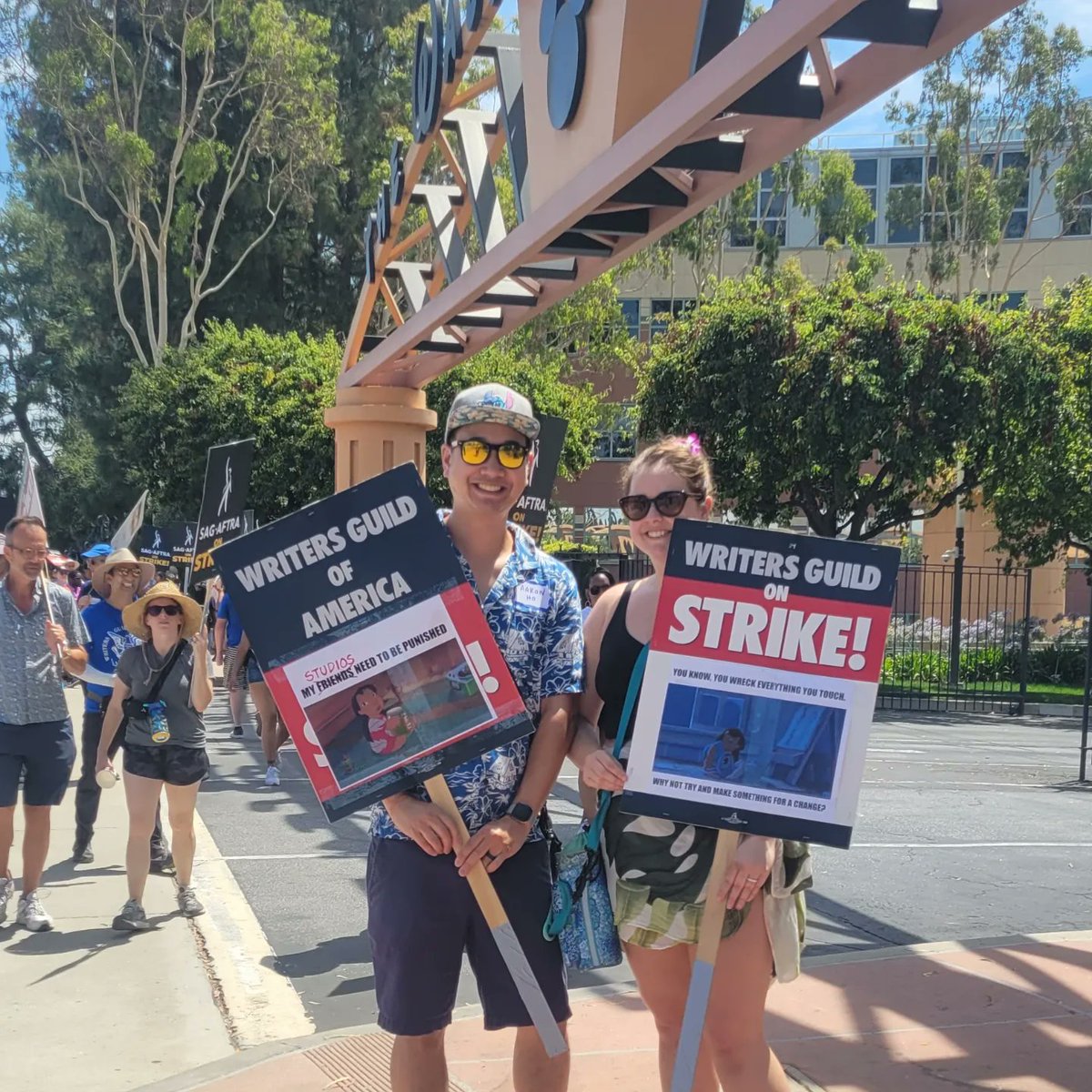 aaron_ho's tweet photo. It was "Ohana Day" on the WGA/SAG-AFTRA picket line at Disney, so @ColiciousNickyP and I busted out our  "Lilo &amp; Stitch"-themed signs. Would you expect anything less?! There was also a strike pony trotting around. 😄 #WGAStrong #SAGAFTRAStrong #ohana🌺 #liloandstitch #ponyup https://t.co/uZ3YUEXDqZ