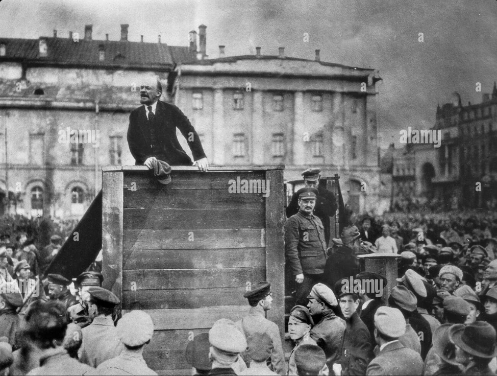 chswiger's tweet image. asked #perplexity_ai to find a photo, then asked questions about the photo : In the second photo, the person standing next to the podium to Lenin's left is Leon Trotsky